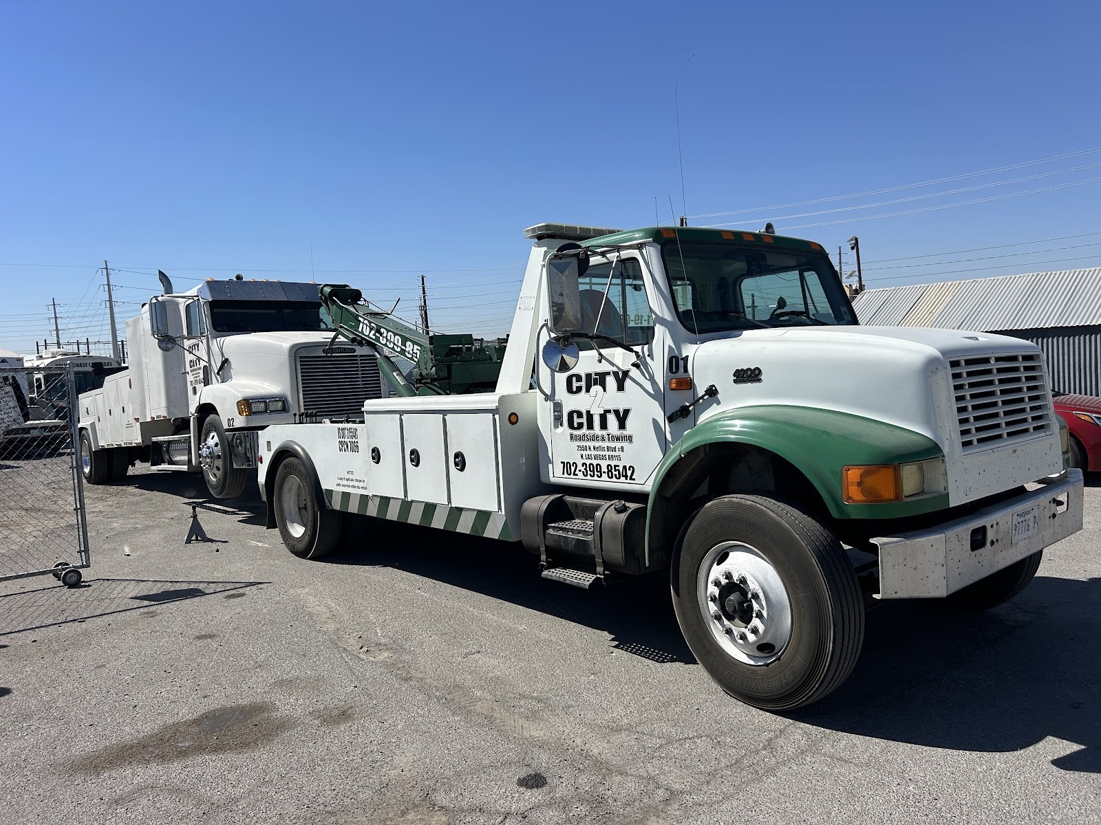 City 2 City green and white International wrecker truck number 01 in the yard